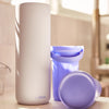 Portable breast milk cooler next to it's respective ice pack and lid with handle