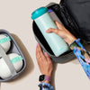 Person packing their portable breast milk cooler into a storage bag